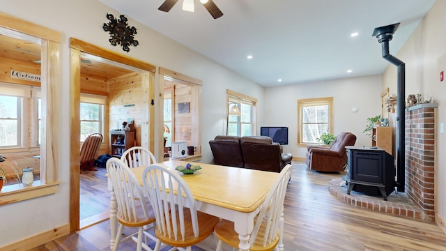 295 Cobb Hill Rd, Otisfield, ME 04270 - dining space with ceiling fan, a wood stove, wood finished floors, baseboards, and recessed lighting