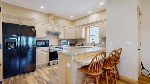 295 Cobb Hill Rd, Otisfield, ME 04270 - kitchen featuring a sink, black appliances, light wood finished floors, and under cabinet range hood