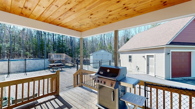 295 Cobb Hill Rd, Otisfield, ME 04270 - wooden deck with grilling area, a forest view, fence, and an outdoor structure
