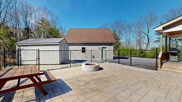 295 Cobb Hill Rd, Otisfield, ME 04270 - view of patio / terrace featuring an outdoor structure, fence, a gate, and an outdoor fire pit