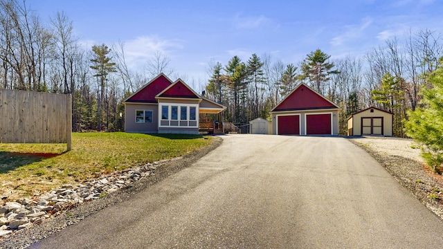 295 Cobb Hill Rd, Otisfield, ME 04270 - view of front of house featuring fence, a storage unit, an outdoor structure, and a garage