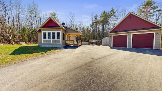 295 Cobb Hill Rd, Otisfield, ME 04270 - view of side of property with a lawn, a detached garage, an outdoor structure, and a storage unit