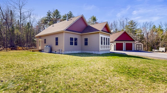 295 Cobb Hill Rd, Otisfield, ME 04270 - view of side of home featuring an outdoor structure, roof with shingles, a yard, and concrete driveway