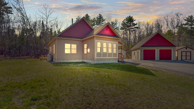 295 Cobb Hill Rd, Otisfield, ME 04270 - view of front of home with a detached garage, a lawn, and an outbuilding