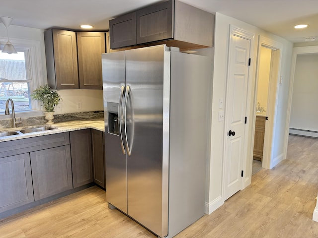 54 Boulder Rd, Raymond, ME 04071 - kitchen featuring stainless steel fridge with ice dispenser, light wood finished floors, a baseboard radiator, recessed lighting, and light stone countertops