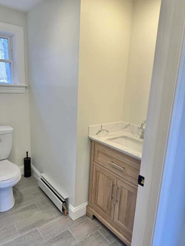 54 Boulder Rd, Raymond, ME 04071 - half bath featuring a baseboard radiator, wood finished floors, and vanity