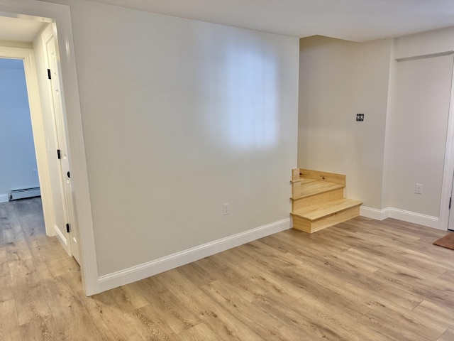 54 Boulder Rd, Raymond, ME 04071 - unfurnished room featuring light wood-type flooring, stairs, and a baseboard heating unit