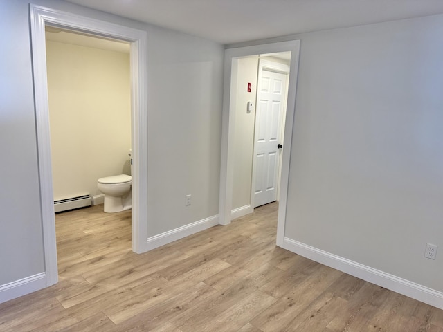 54 Boulder Rd, Raymond, ME 04071 - unfurnished bedroom featuring a baseboard heating unit, light wood-style floors, and ensuite bathroom