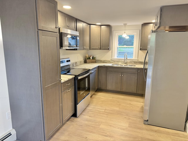 54 Boulder Rd, Raymond, ME 04071 - kitchen featuring stainless steel appliances, light wood finished floors, light stone counters, a baseboard heating unit, and hanging light fixtures