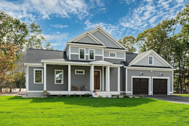 37 Cascade Cir Unit 26, Kennebunk, ME 04043 - view of front of property featuring board and batten siding, a porch, a front lawn, and aphalt driveway