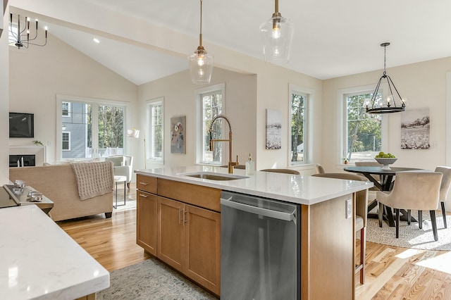37 Cascade Cir Unit 26, Kennebunk, ME 04043 - kitchen featuring light wood finished floors, a wealth of natural light, stainless steel dishwasher, and a sink