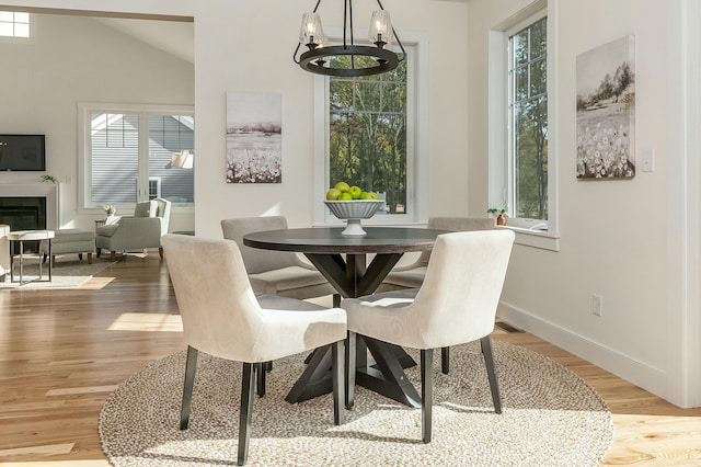 37 Cascade Cir Unit 26, Kennebunk, ME 04043 - dining room with plenty of natural light, baseboards, wood finished floors, and an inviting chandelier