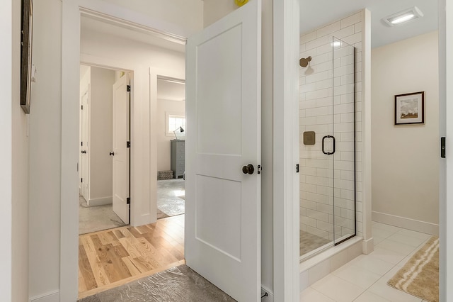 37 Cascade Cir Unit 26, Kennebunk, ME 04043 - bathroom with baseboards, wood finished floors, and a stall shower
