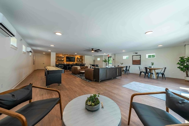 37 Cascade Cir Unit 26, Kennebunk, ME 04043 - living area with baseboards, light wood-style flooring, a wall mounted AC, and recessed lighting