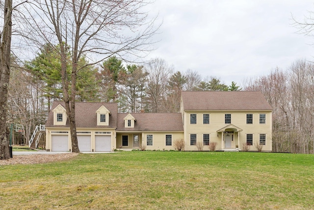 colonial-style house featuring driveway and a front lawn