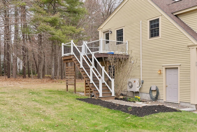 rear view of house featuring stairs, ac unit, a lawn, and a deck