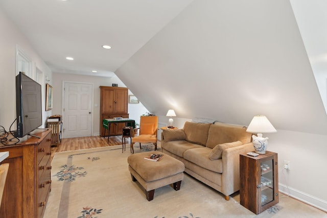 living room featuring recessed lighting, baseboards, vaulted ceiling, and light wood-type flooring