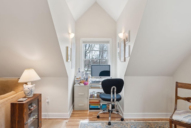 home office with baseboards, lofted ceiling, and wood finished floors