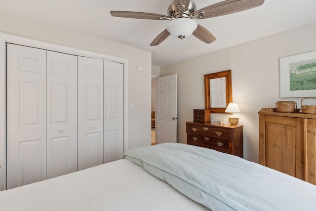 bedroom with a ceiling fan and a closet