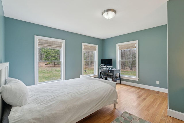 bedroom with baseboards and light wood-type flooring