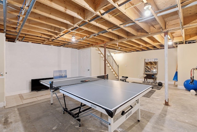 game room featuring concrete flooring and baseboards