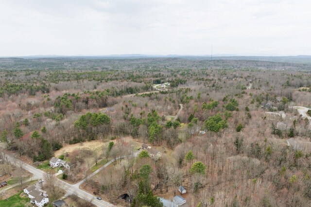 drone / aerial view with a wooded view