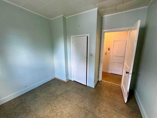 unfurnished bedroom featuring baseboards and ornamental molding