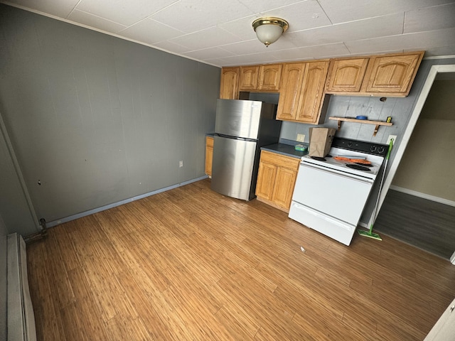 334 Main St, Madawaska, ME 04756 - kitchen with electric range, freestanding refrigerator, baseboards, and light wood-style floors