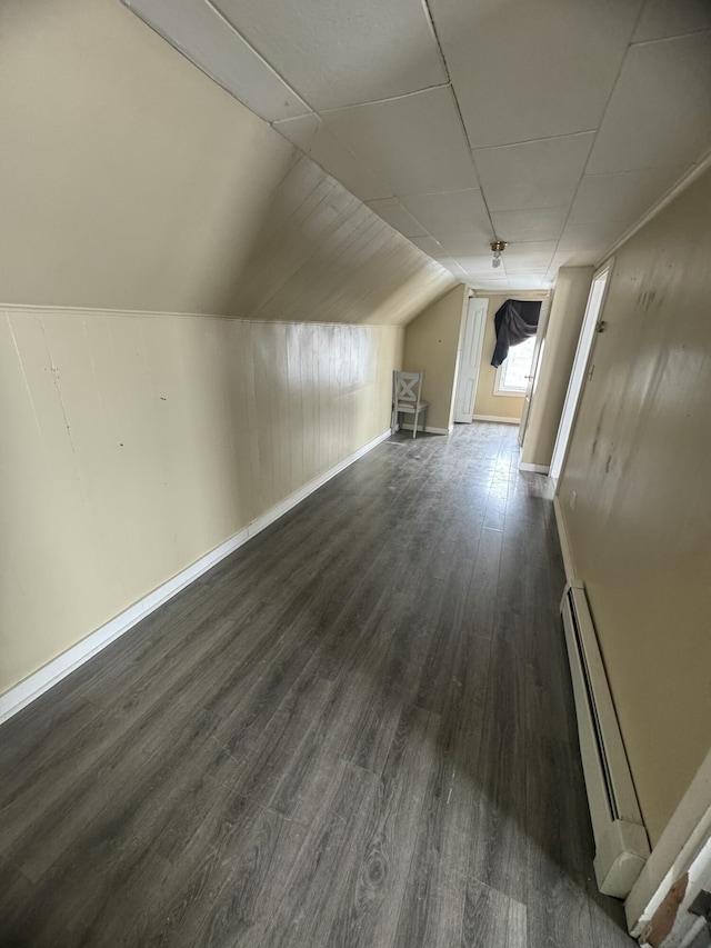 334 Main St, Madawaska, ME 04756 - additional living space with a baseboard heating unit, dark wood-style floors, lofted ceiling, and baseboards