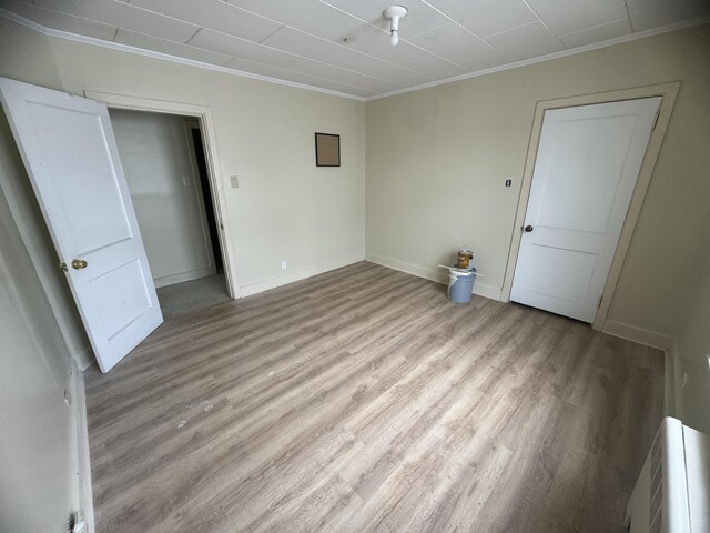 334 Main St, Madawaska, ME 04756 - spare room with crown molding, light wood-style floors, and baseboards
