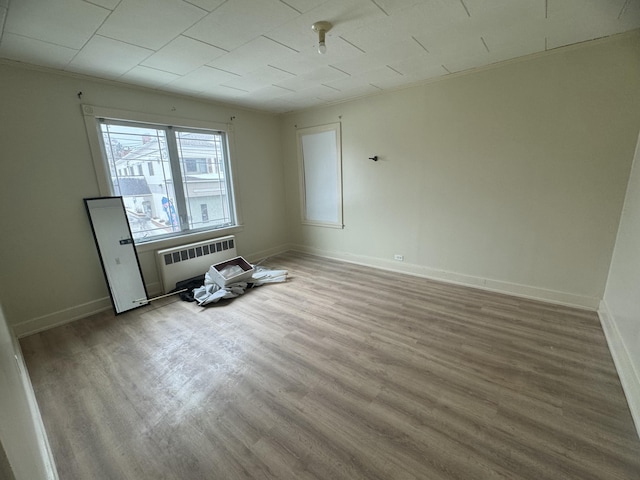 334 Main St, Madawaska, ME 04756 - unfurnished room with radiator, wood finished floors, and baseboards