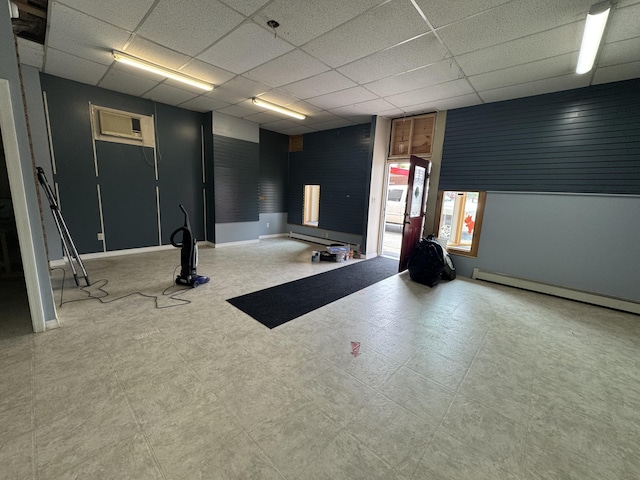 334 Main St, Madawaska, ME 04756 - below grade area featuring baseboard heating, a drop ceiling, and baseboards