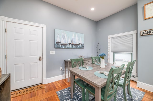 dining room with recessed lighting, wood finished floors, and baseboards