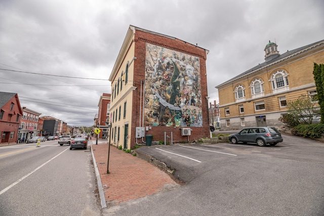 view of building exterior featuring uncovered parking