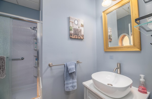 bathroom featuring a shower stall and vanity