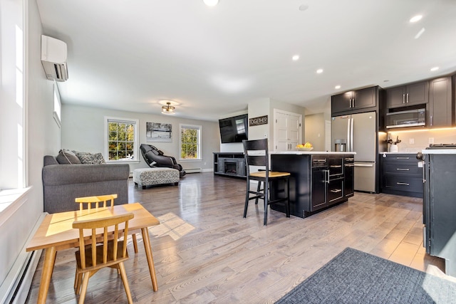 64 Rolling Brook Rd, Raymond, ME 04071 - kitchen featuring a center island, stainless steel refrigerator with ice dispenser, an AC wall unit, baseboard heating, and open floor plan