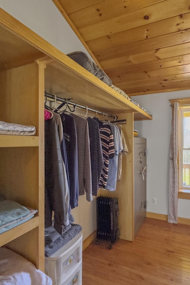 walk in closet with wood finished floors