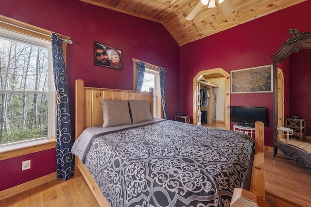 bedroom with a ceiling fan, wooden ceiling, wood finished floors, and lofted ceiling