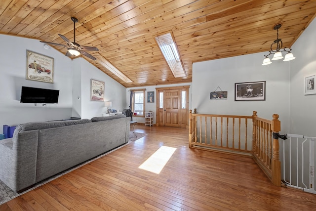 living area featuring a ceiling fan, vaulted ceiling, hardwood / wood-style flooring, and wood ceiling