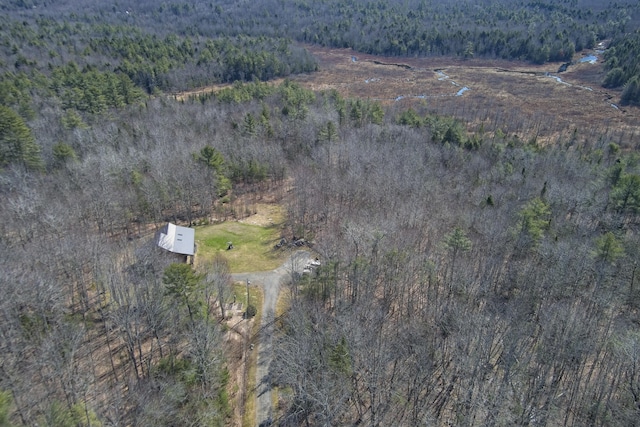 drone / aerial view with a wooded view