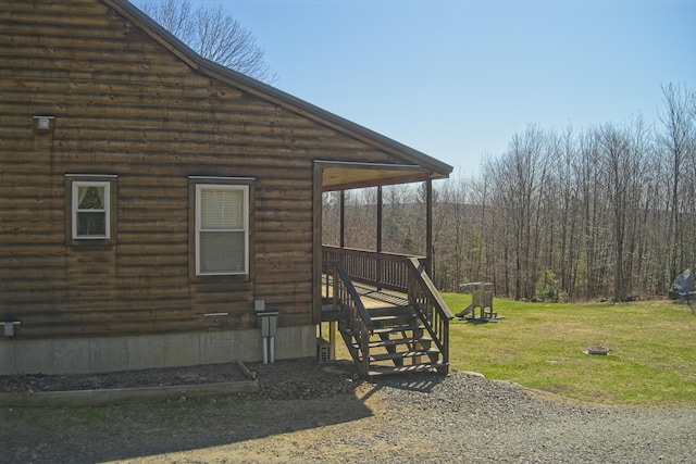 view of home's exterior featuring a lawn and stairs
