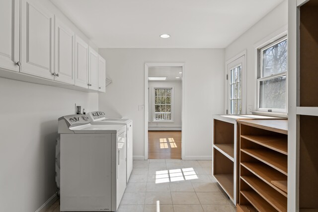 washroom with light tile patterned flooring, baseboards, recessed lighting, separate washer and dryer, and cabinet space