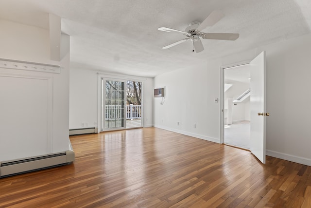 unfurnished living room with baseboards, wood finished floors, a ceiling fan, and baseboard heating