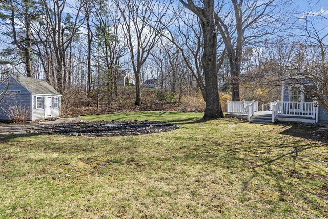 view of yard with an outdoor structure and a wooden deck