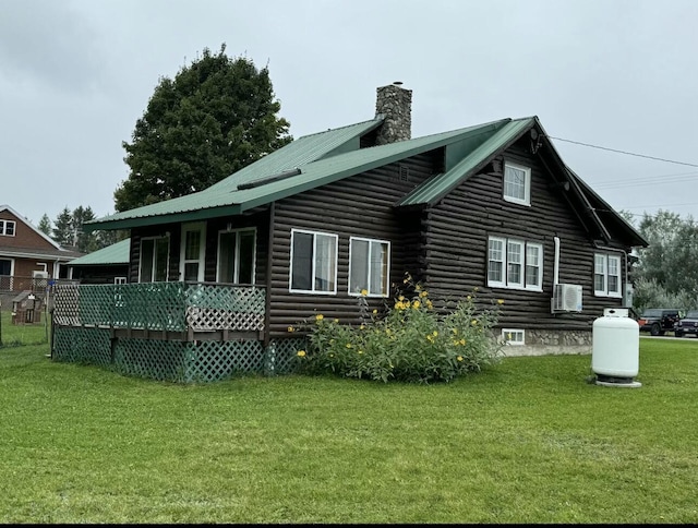 101 Mechanic St, Presque Isle, ME 04769 - rear view of house featuring a lawn, a chimney, metal roof, and log siding