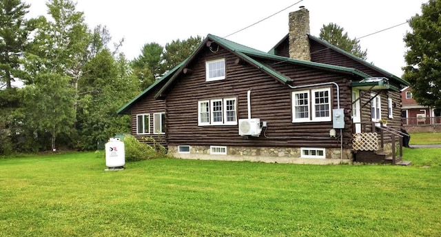 101 Mechanic St, Presque Isle, ME 04769 - rear view of house featuring a lawn, ac unit, a chimney, and log siding