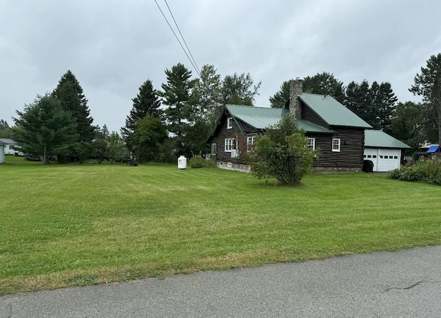 101 Mechanic St, Presque Isle, ME 04769 - view of property exterior with a chimney, metal roof, and a lawn