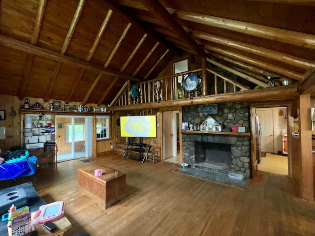 101 Mechanic St, Presque Isle, ME 04769 - living area featuring wood finished floors, high vaulted ceiling, and a stone fireplace