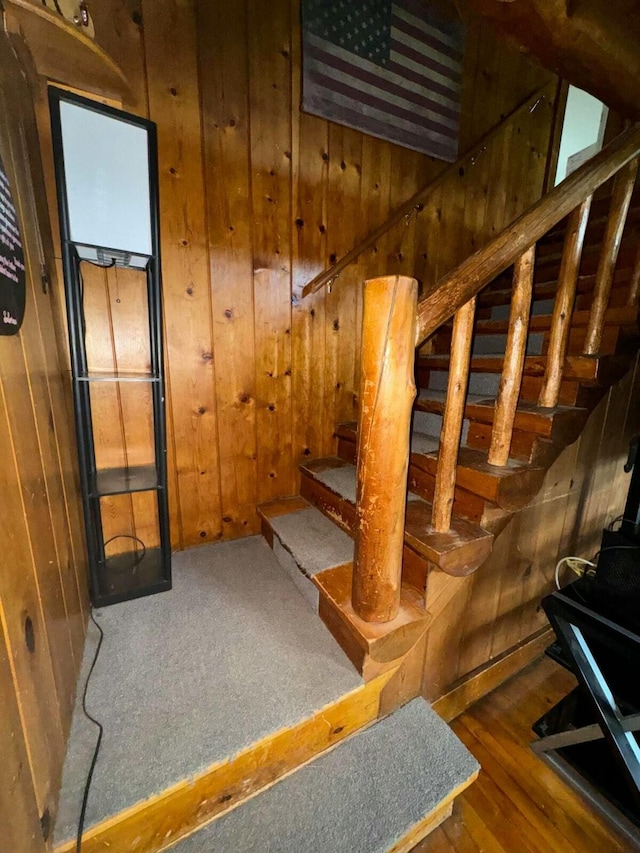101 Mechanic St, Presque Isle, ME 04769 - stairs with wooden walls, wood finished floors, and a wood stove