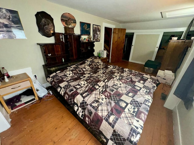 101 Mechanic St, Presque Isle, ME 04769 - bedroom featuring wood-type flooring and attic access